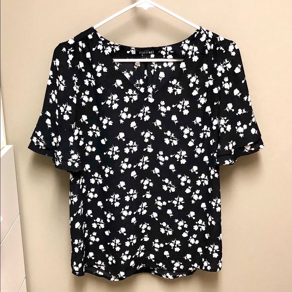 Black blouse with white floral detail